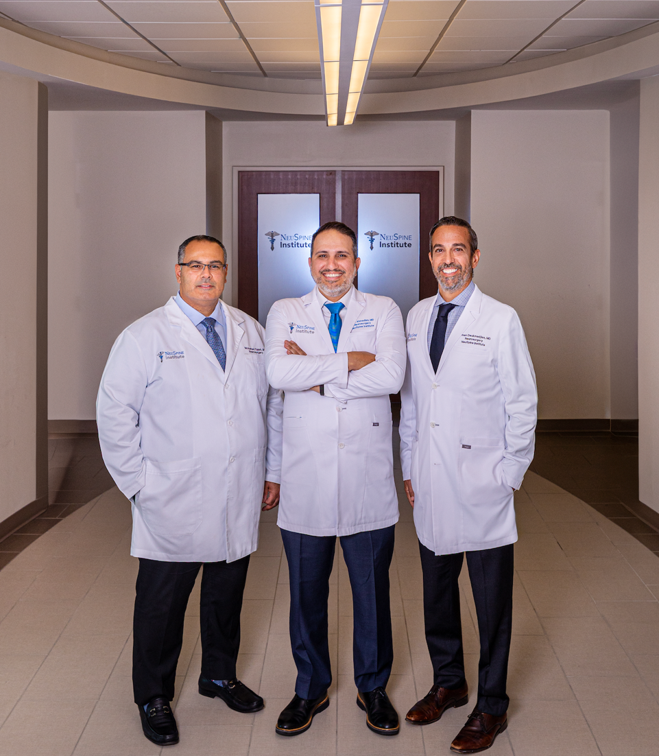 Dr. Saleh, Dr. Ahmadian and Dr. Deukmedjian standing in the hallway at NeuSpine Institute